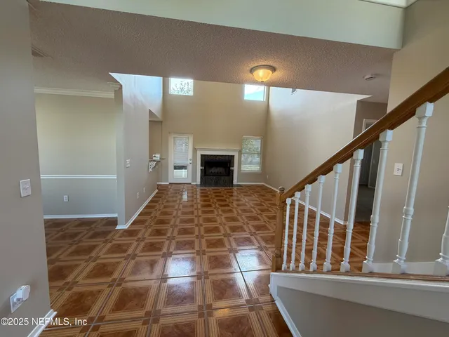 a view of an entryway with wooden floor