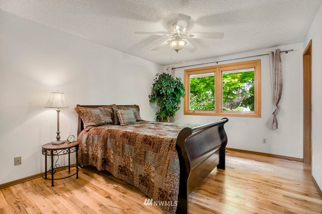121 Union Court Northeast Renton, WA 98059 - Photo 11 of 21 a bed sitting in a bedroom next to a window