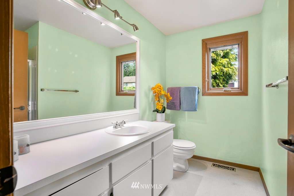 121 Union Court Northeast Renton, WA 98059 - Photo 13 of 21 a bathroom with a sink a toilet and mirror