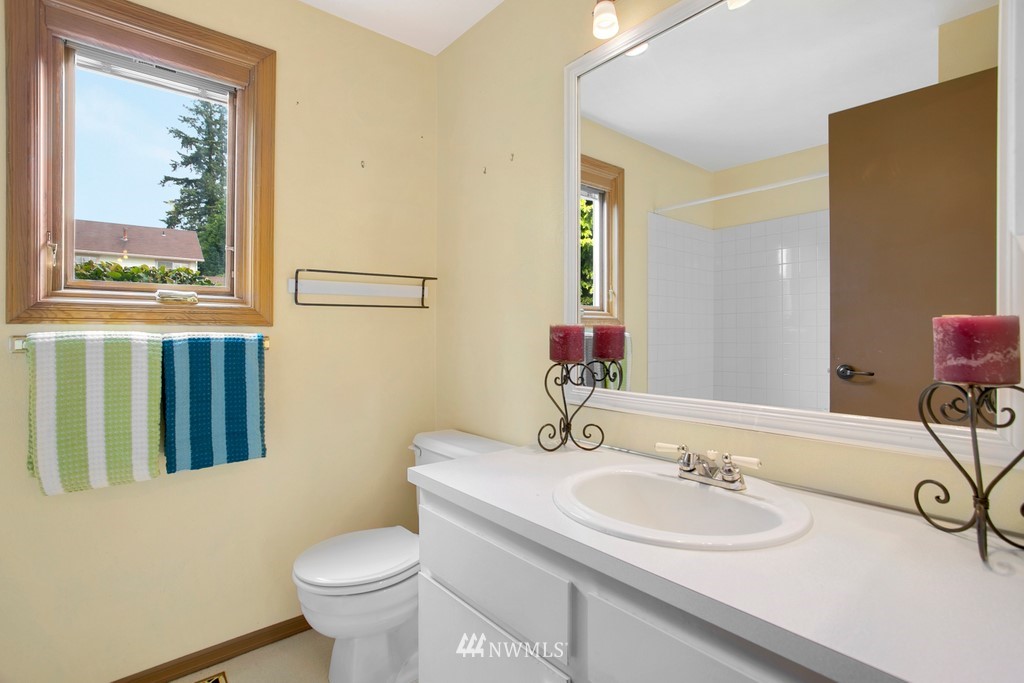 121 Union Court Northeast Renton, WA 98059 - Photo 17 of 21 a bathroom with a toilet sink and mirror