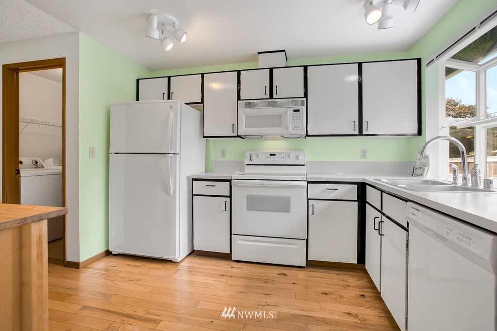 121 Union Court Northeast Renton, WA 98059 - Photo 10 of 21 a kitchen with a refrigerator sink stove and cabinets