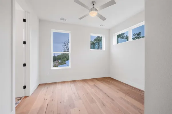 a kitchen with a table chairs refrigerator and microwave