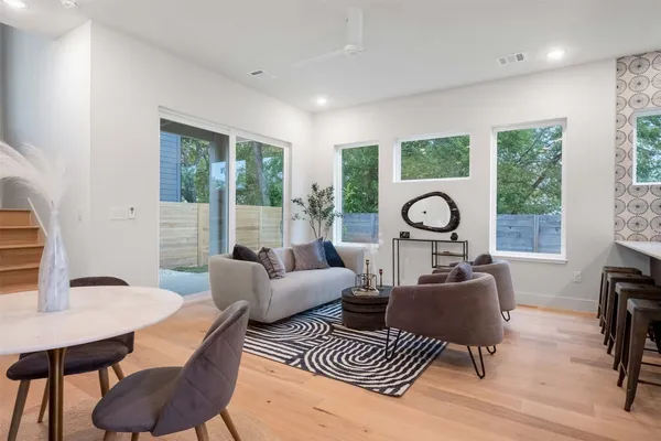 a living room with furniture a table and a large window