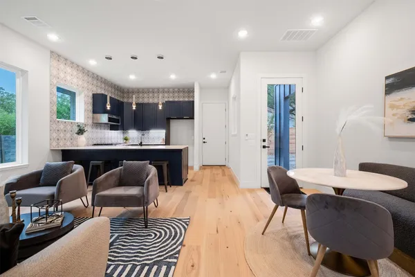 a dining room with furniture and a wooden floor