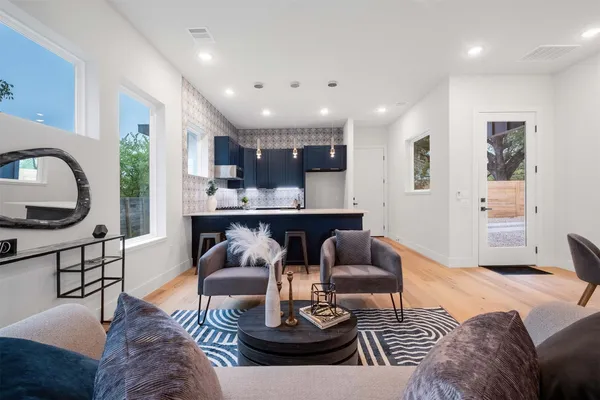 a living room with furniture and a wooden floor