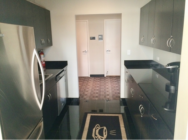 8 East Randolph Street, Unit 1002 Chicago, IL 60601 - Photo 22 of 23 a kitchen with a refrigerator and cabinets
