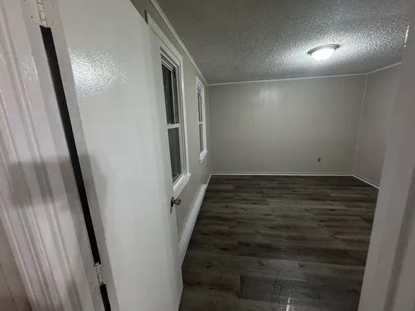 en empty room with wooden floor and window