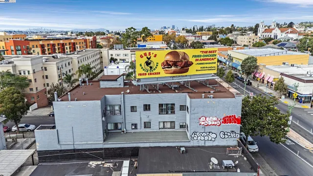 an aerial view of a building with outdoor space and seating