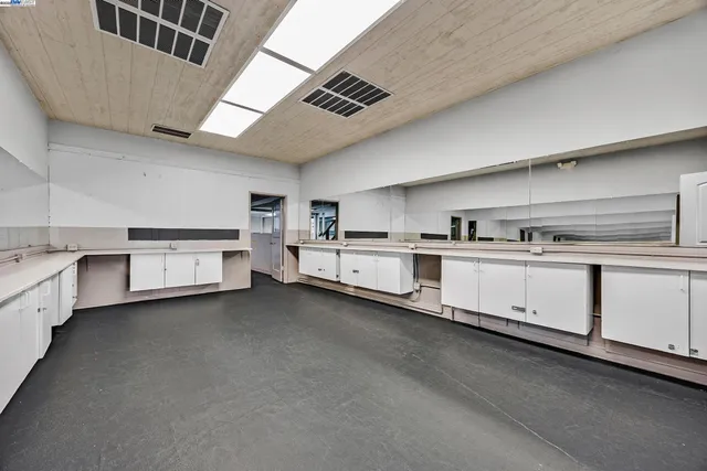 a white refrigerator freezer and a stove sitting inside of a kitchen
