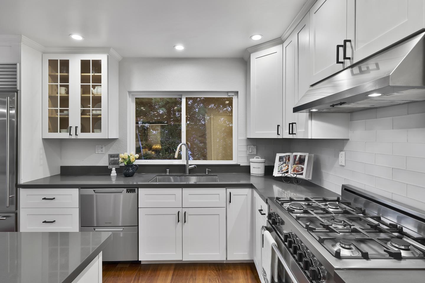 20 Tea Tree Court Hillsborough, CA 94010 - Photo 39 of 100 a kitchen with stainless steel appliances a sink stove and cabinets