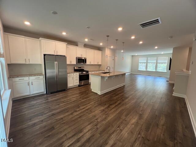 2819 Macbeth Lane Apex, NC 27502 - Photo 11 of 62 a kitchen with stainless steel appliances a refrigerator and wooden floor