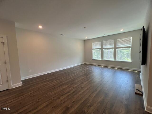 2819 Macbeth Lane Apex, NC 27502 - Photo 12 of 62 an empty room with wooden floor and windows