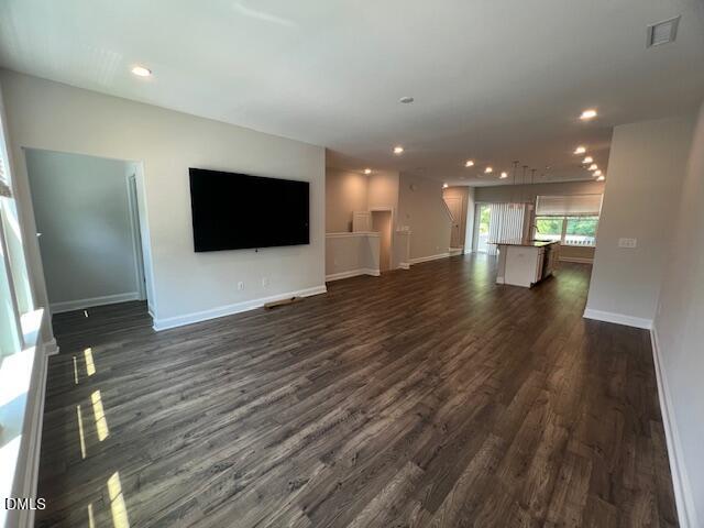 2819 Macbeth Lane Apex, NC 27502 - Photo 13 of 62 an empty room with wooden floor and windows