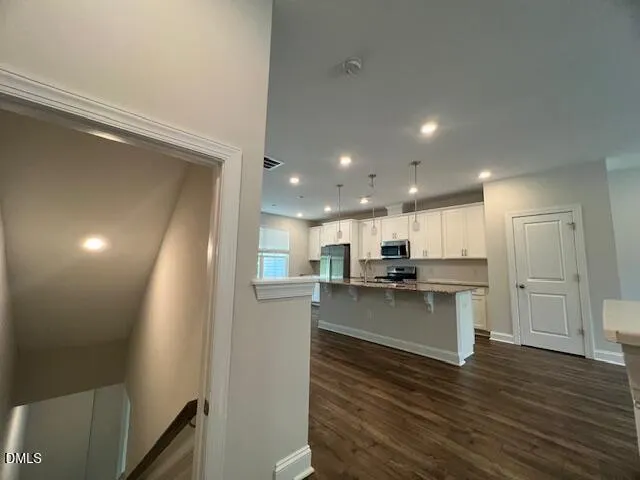 a kitchen with a sink and wooden floor