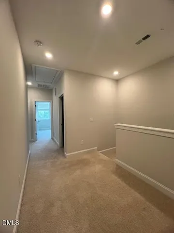 an empty room with closet area and windows