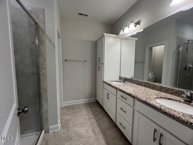 2819 Macbeth Lane Apex, NC 27502 - Photo 29 of 62 a bathroom with a granite countertop sink and a mirror