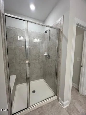 a view of a hallway with a livingroom and a bathroom