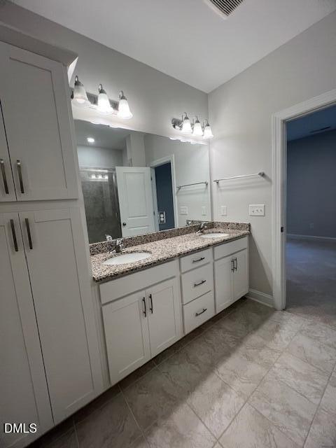 2819 Macbeth Lane Apex, NC 27502 - Photo 31 of 62 a bathroom with a double vanity sink and a mirror