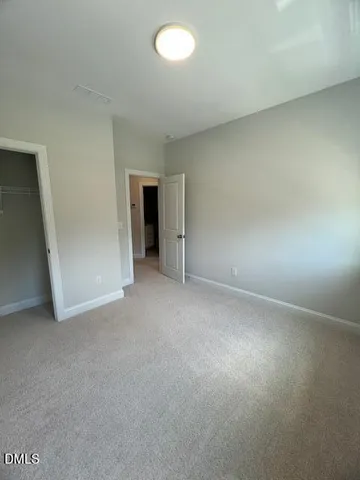 an empty room with a empty space and windows