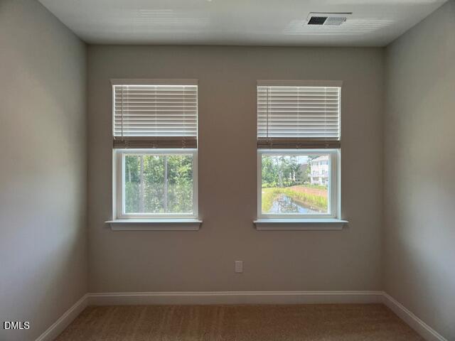 2819 Macbeth Lane Apex, NC 27502 - Photo 38 of 62 a view of an empty room with wooden floor and a window