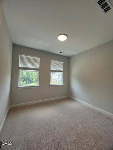 a balcony with wooden floor and fence