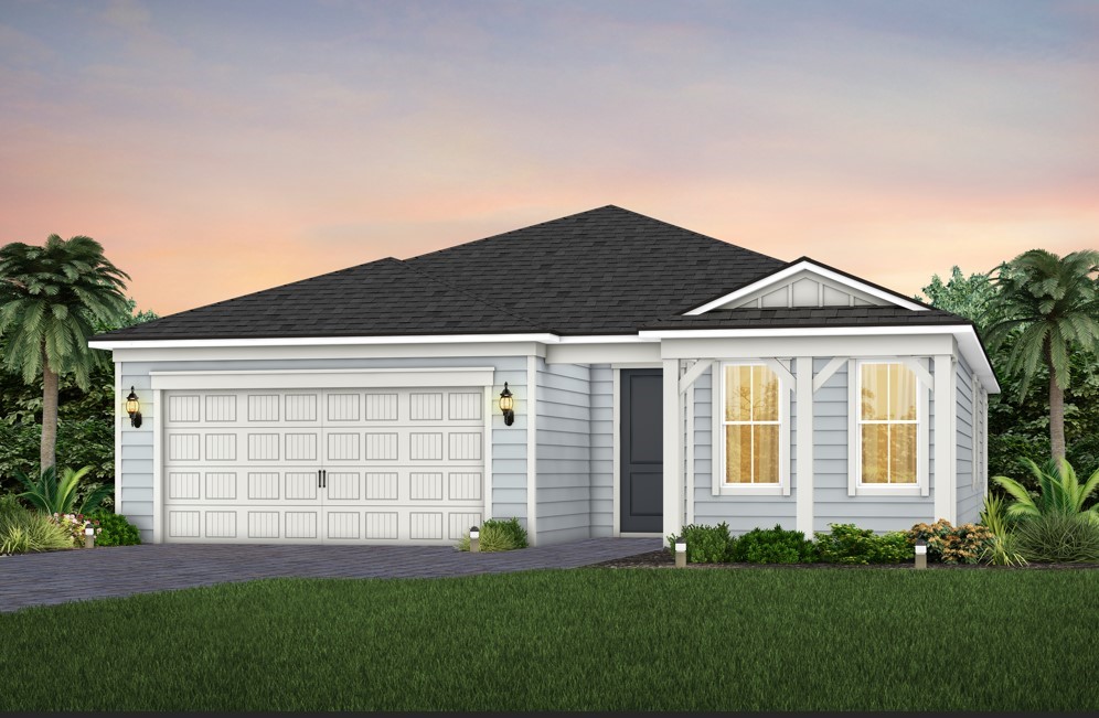 a front view of a house with a garden and yard