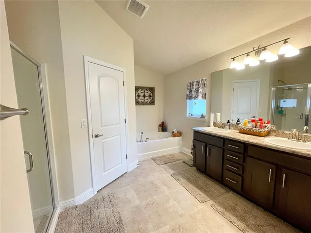 a spacious bathroom with a sink mirror and a bath tub
