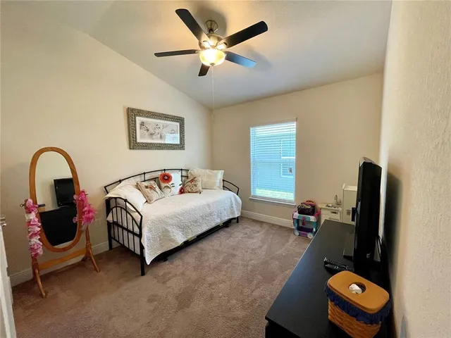 a bedroom with a bed and a desk