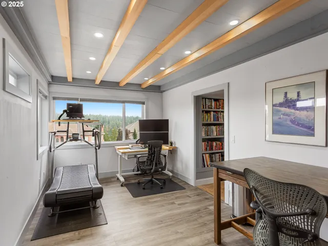 a view of a livingroom with workspace and a window