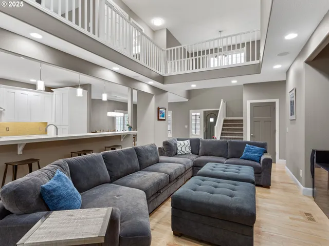 a living room with furniture and a ceiling fan