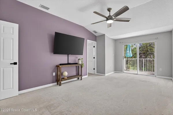 a view of a livingroom with an empty space and a ceiling fan