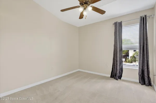 an empty room with a empty space and a ceiling fan