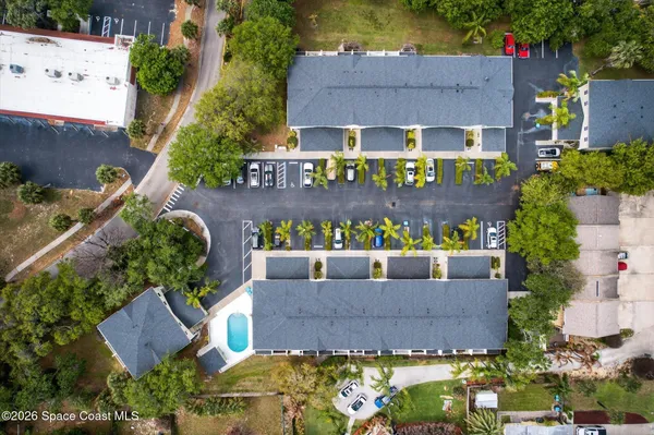 a aerial view of a house with a yard and potted plants