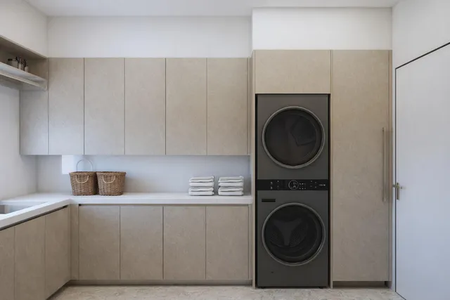 a utility room with sink dryer and washer