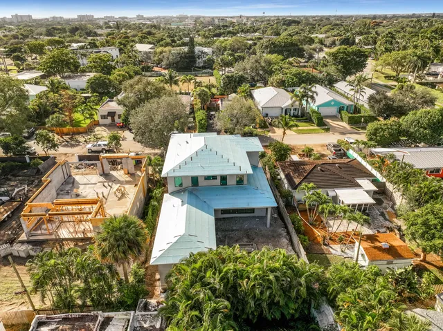 an aerial view of residential houses with yard