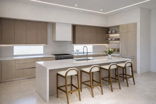 a kitchen with appliances cabinets and chair