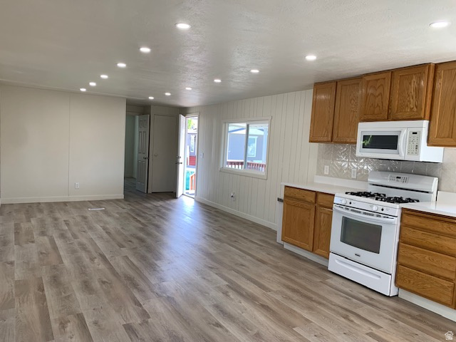 1500 North Angel Street West, Unit 56 Layton, UT 84041 - Photo 11 of 20 Kitchen featuring light countertops, white appliances, wood finish cabinets, recessed lighting, and light wood-type flooring