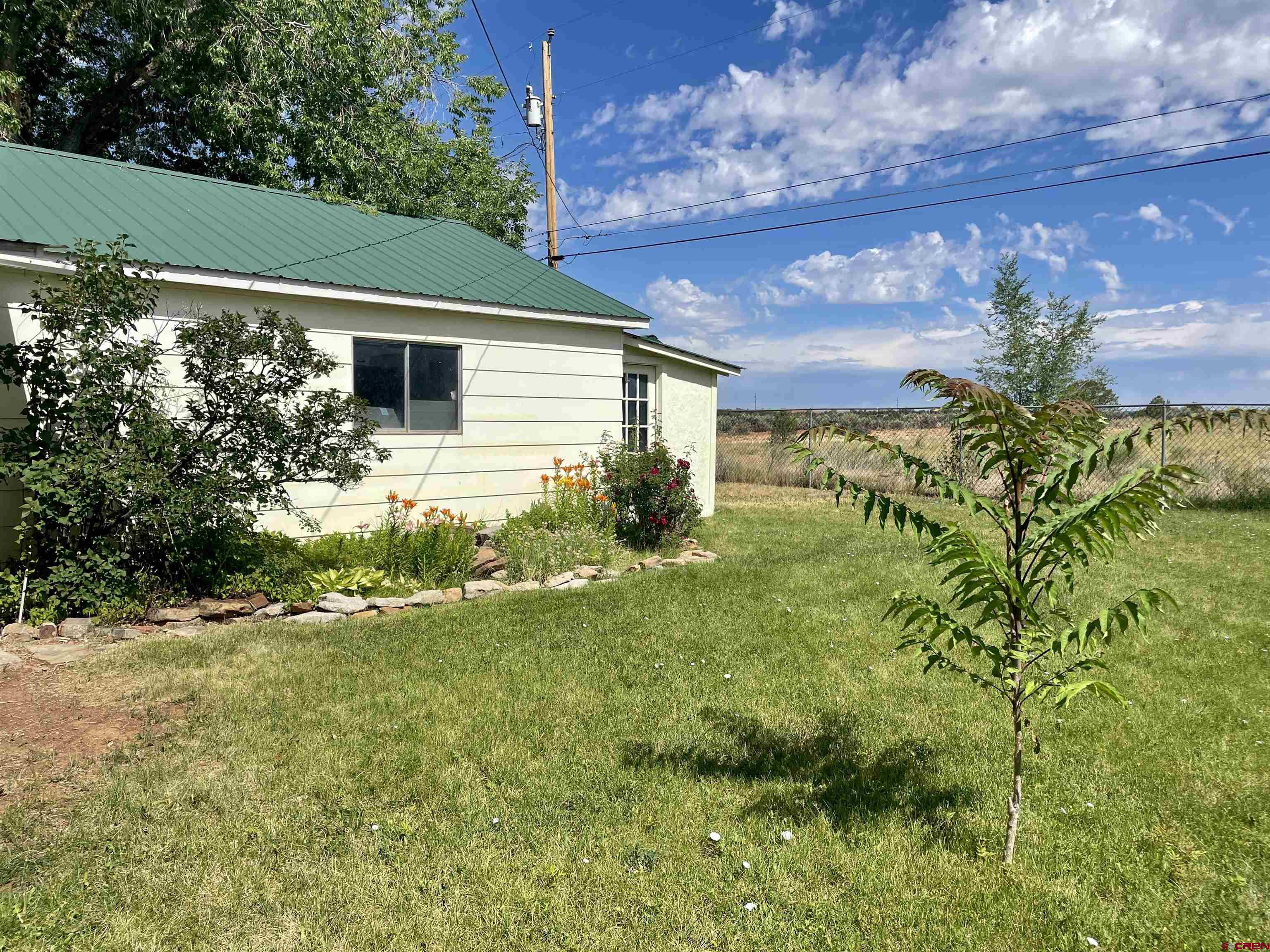 710 Canyon Drive Cortez, CO 81321 - Photo 22 of 23 a backyard of a house with lots of green space