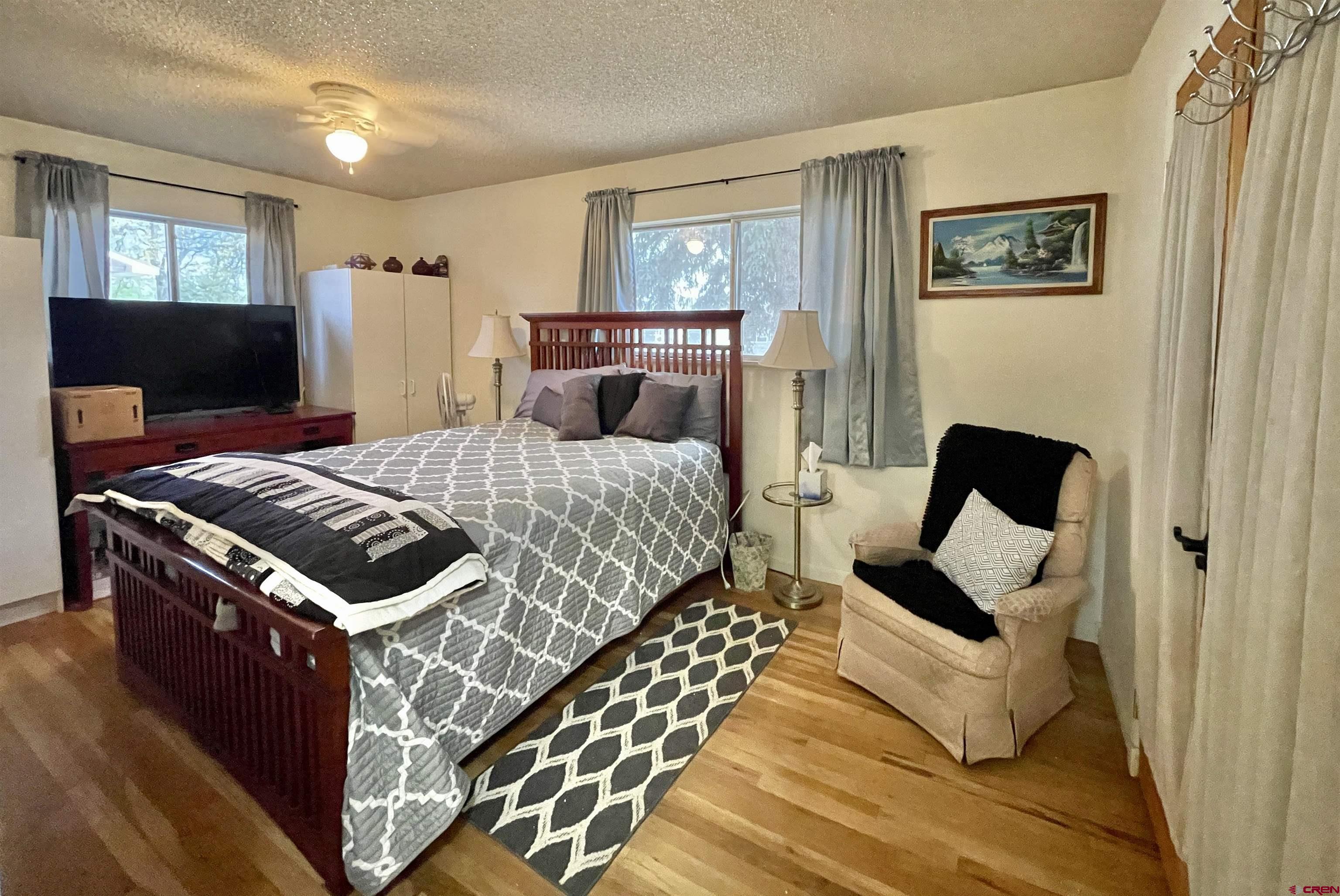 710 Canyon Drive Cortez, CO 81321 - Photo 10 of 23 a bedroom with a bed and a mirror