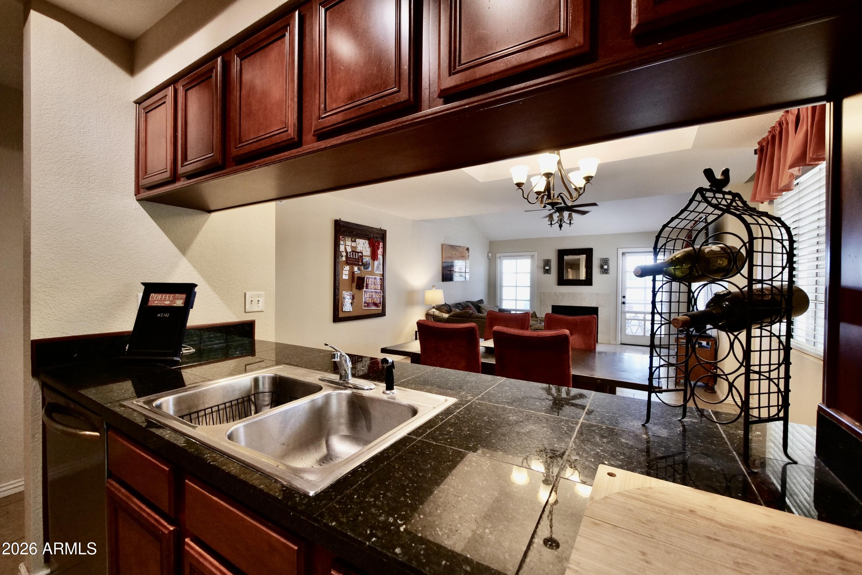 1222 West Baseline Road, Unit 156 Tempe, AZ 85283 - Photo 13 of 27 a kitchen with a sink a stove and cabinets
