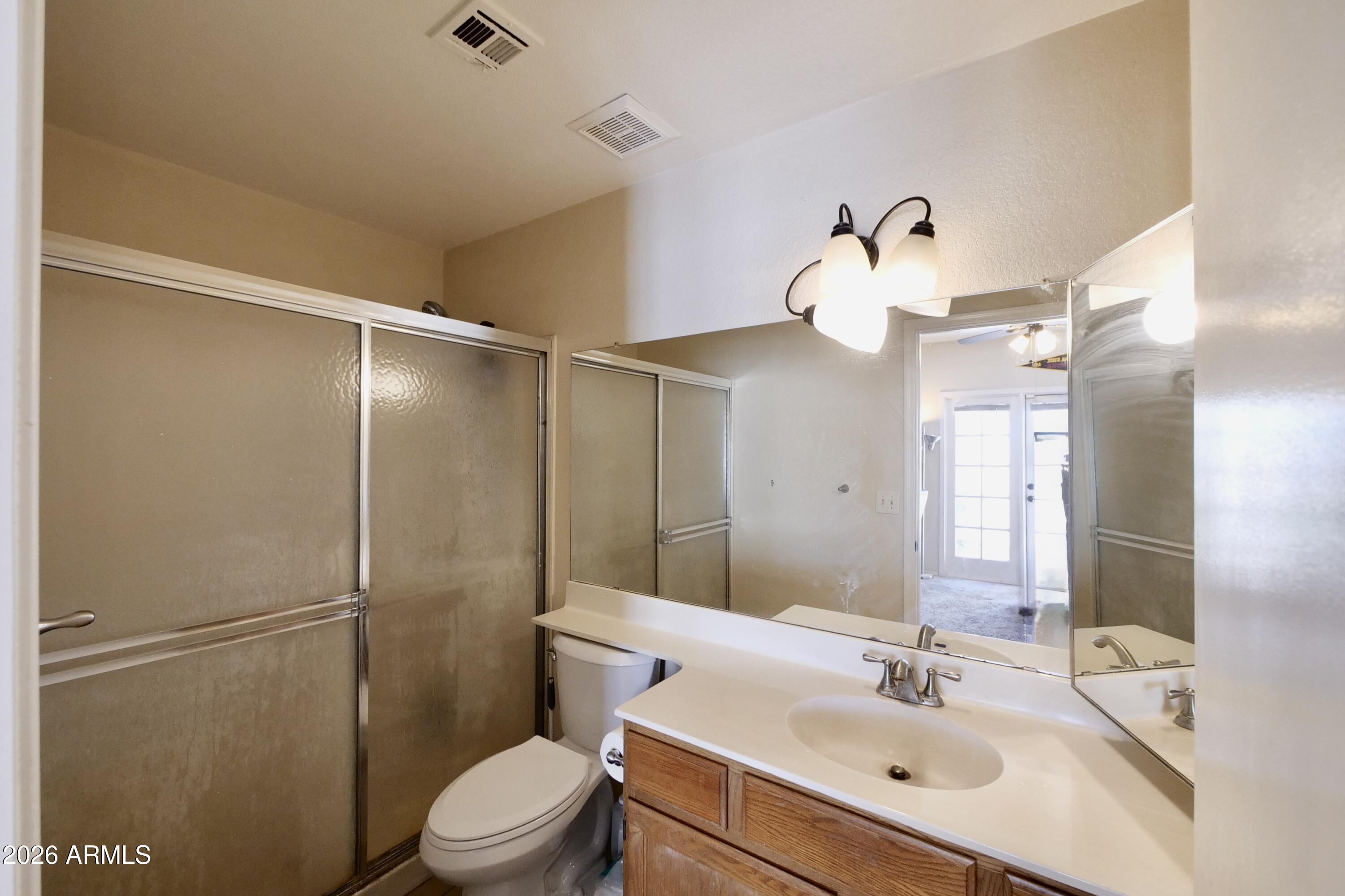 1222 West Baseline Road, Unit 156 Tempe, AZ 85283 - Photo 17 of 27 a bathroom with a sink a toilet and a mirror