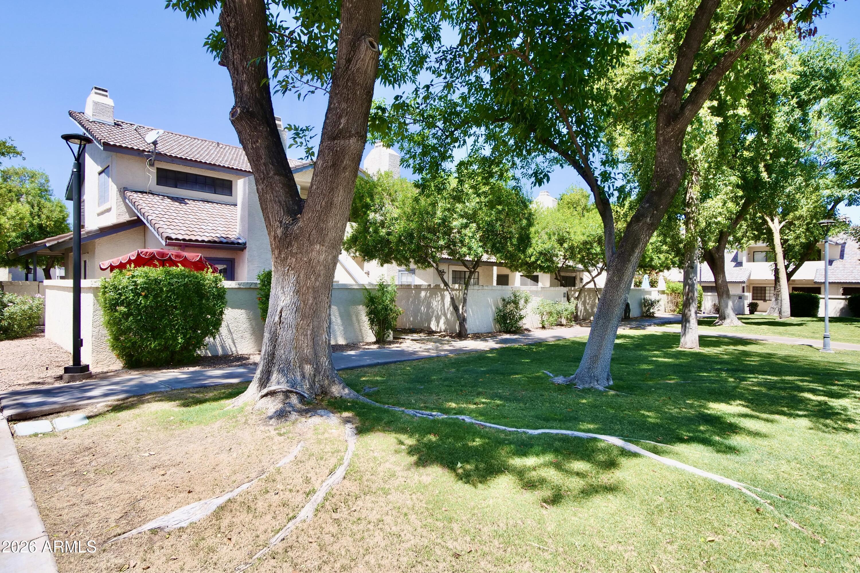 1222 West Baseline Road, Unit 156 Tempe, AZ 85283 - Photo 26 of 27 a front view of a house with garden
