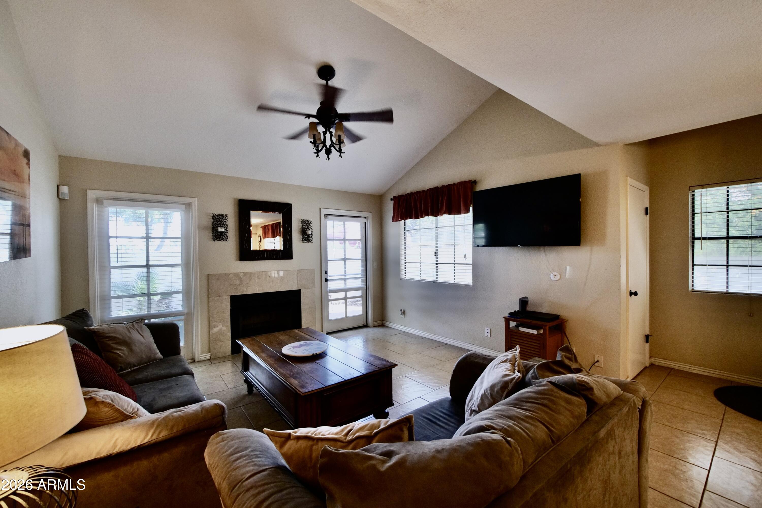 1222 West Baseline Road, Unit 156 Tempe, AZ 85283 - Photo 6 of 27 a living room with furniture a flat screen tv and a fireplace