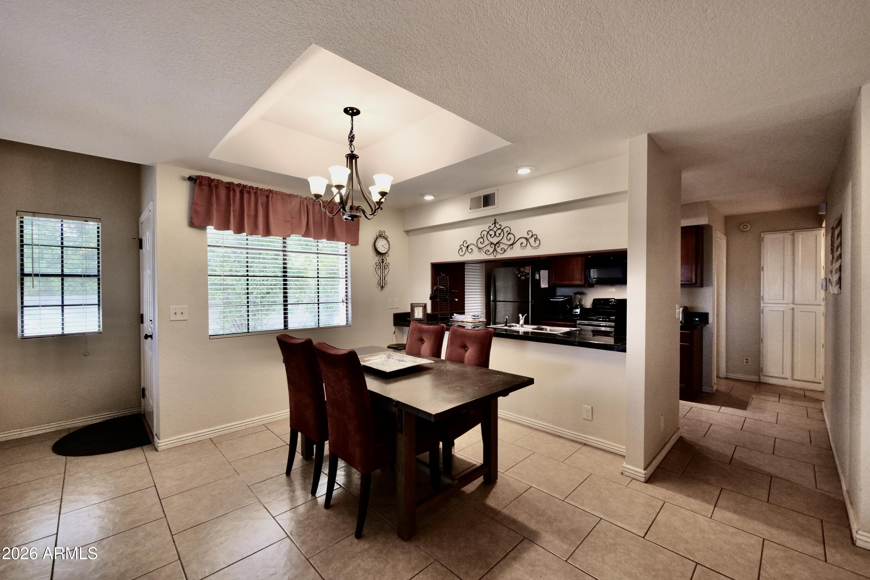 1222 West Baseline Road, Unit 156 Tempe, AZ 85283 - Photo 10 of 27 a dining room with furniture and window
