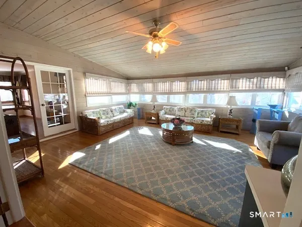 a living room with furniture a window and gym equipment