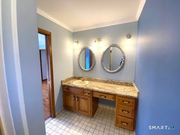 a bathroom with a toilet and a glass door shower