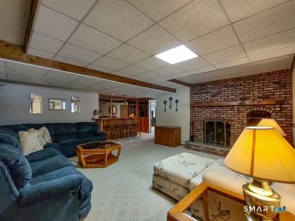a room with lots of wooden furniture and a view of living room