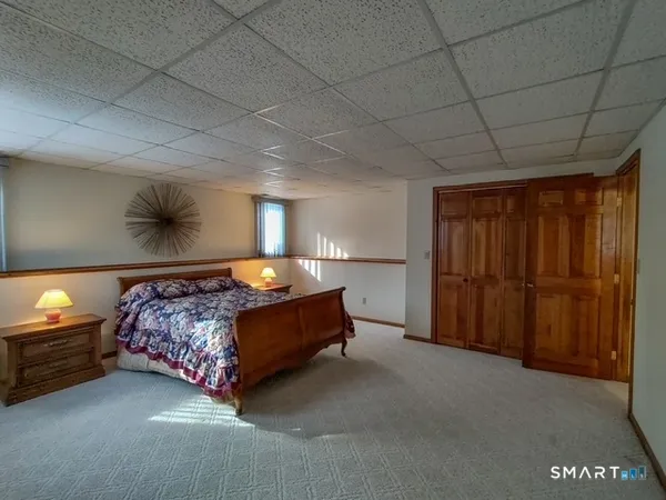 a bed sitting in a bedroom next to a larger window