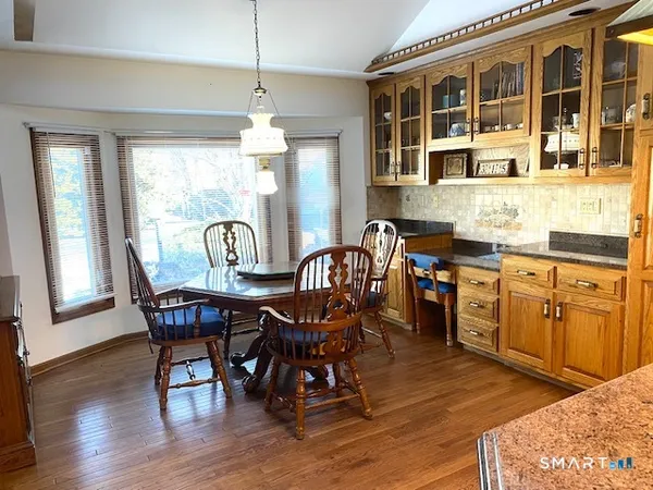 a view of a dining room with furniture window and wooden floor