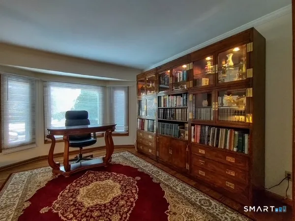 a living room with furniture lamp and a rug